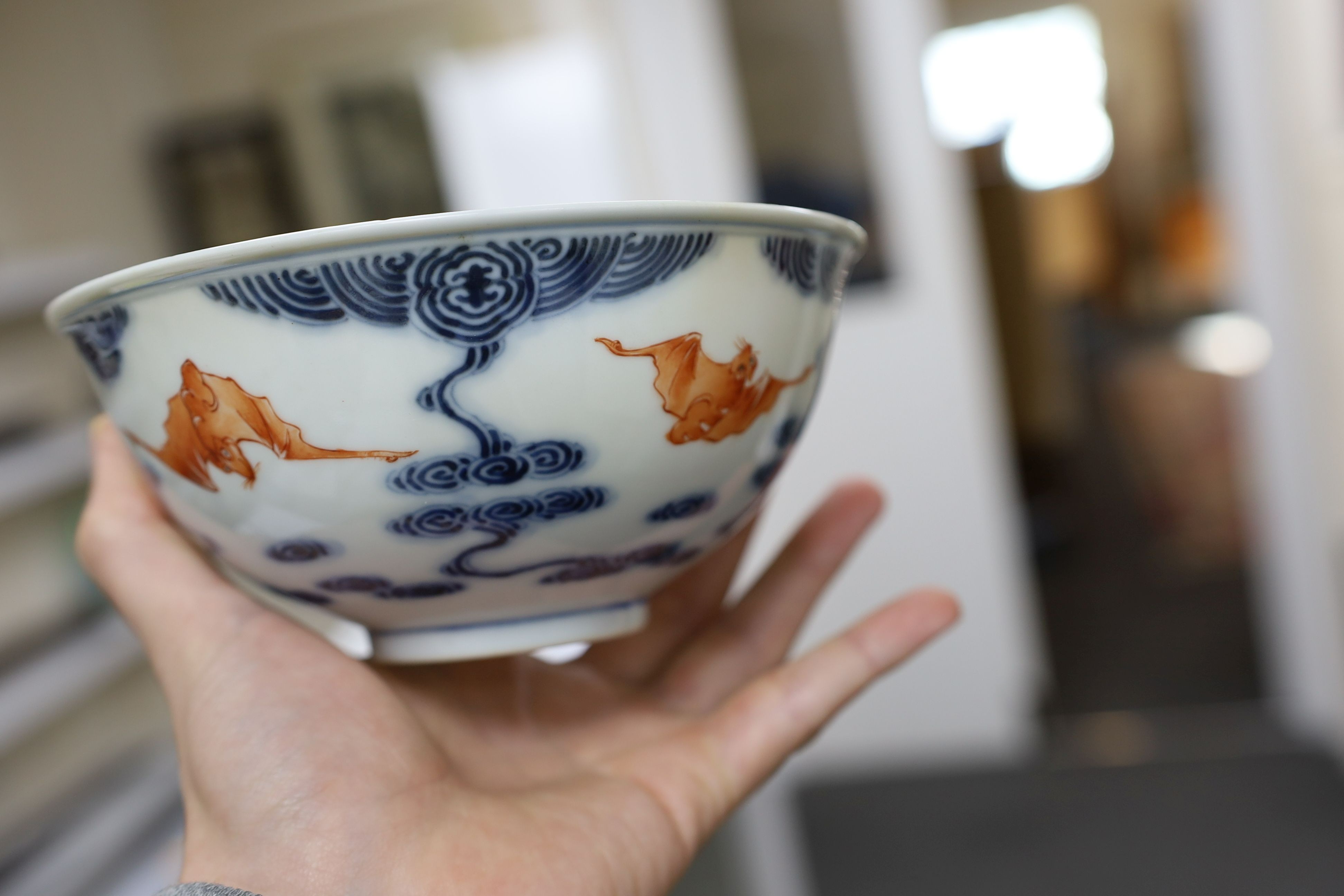 A pair of Chinese iron red and underglaze blue ‘five bat’ bowls, Guangxu mark and probably of the period (1875-1908), 16.5cm diameter